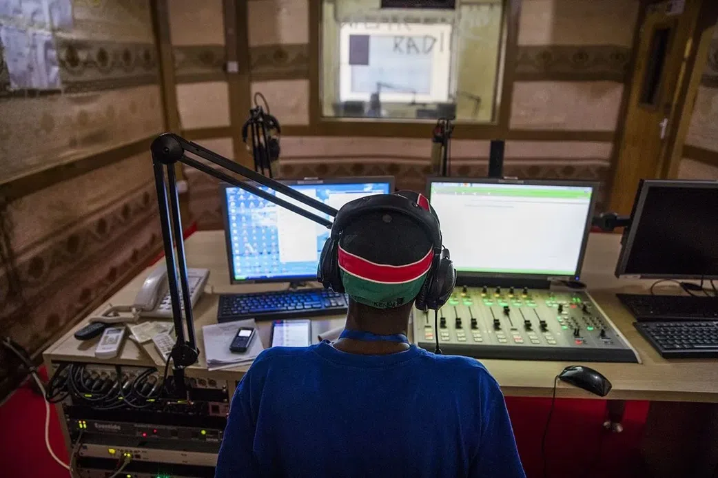 A radio presenter inside a studio