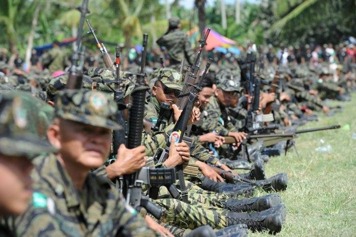 Moro Islamic Liberation Front (MILF) rebels gather inside their camp, as thousands of its members and residents arrive for a rally in support of the peace in 2014
