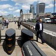Pedestrians walk pass newly installed barriers on the pavement on London Bridge following the June 3 terror attack in London which killed seven people and injured 48.