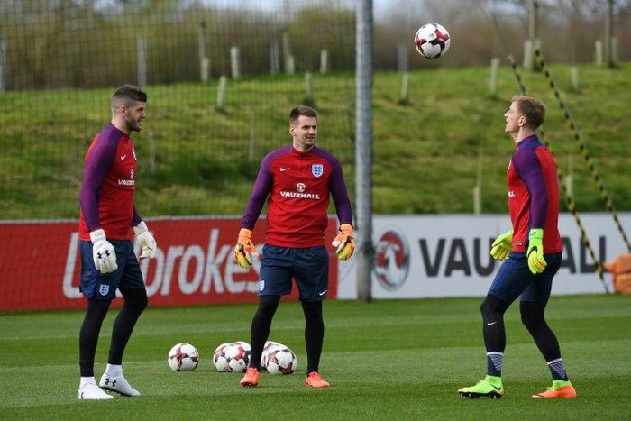 (L-R) England goalkeepers Fraser Forster, Tom Heaton and Joe Hart take part in a team training session at St George's Park in Burton-on-Trent, central England on March 21, 2017