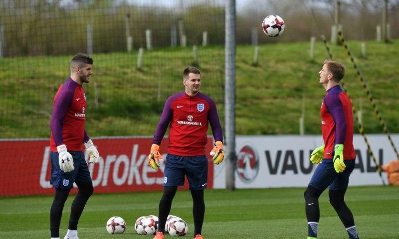 (L-R) England goalkeepers Fraser Forster, Tom Heaton and Joe Hart take part in a team training session at St George's Park in Burton-on-Trent, central England on March 21, 2017