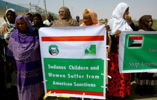 Sudanese representatives of various humanitarian organisations take part in a protest outside the US embassy in Khartoum on September 16, 2015, against the sanctions imposed on the country