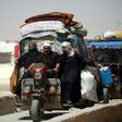 Displaced Syrians drive on June 10, 2017 at a temporary camp in the northern Syrian village of Ain Issa, where many people who fled the Islamic State group stronghold of Raqa are taking shelter