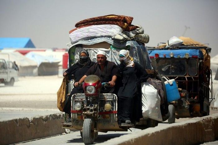 Displaced Syrians drive on June 10, 2017 at a temporary camp in the northern Syrian village of Ain Issa, where many people who fled the Islamic State group stronghold of Raqa are taking shelter