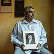 Imtiaz Cajee, the nephew of Ahmed Timol, an anti-apartheid activist brutally murdered in police custody in October 1971, holds a portrait of his uncle at his house in Pretoria