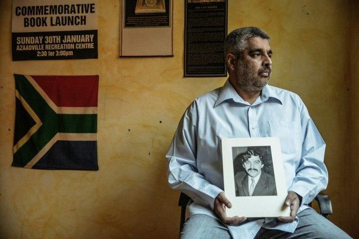 Imtiaz Cajee, the nephew of Ahmed Timol, an anti-apartheid activist brutally murdered in police custody in October 1971, holds a portrait of his uncle at his house in Pretoria