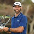 Dustin Johnson of the US poses with the trophy after putting for birdie on the 18th green to defeat compatriot Jordan Spieth in a playoff to win The Northern Trust, at Glen Oaks Club in Westbury, New York, on August 27, 2017