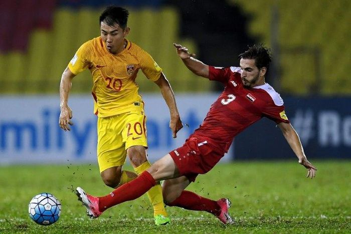 Yu Hanchao of China (L) vies for the ball with Mouaiad Al Ajjan (R) of Syria during the FIFA World Cup 2018 Group A third round qualifying match June 13, 2017
