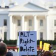 A demonstrator holds a sign in front of the White House during a vigil in response to the death of a counter-protestor in the August 12 "Unite the Right" rally in Charlottesville, Virginia