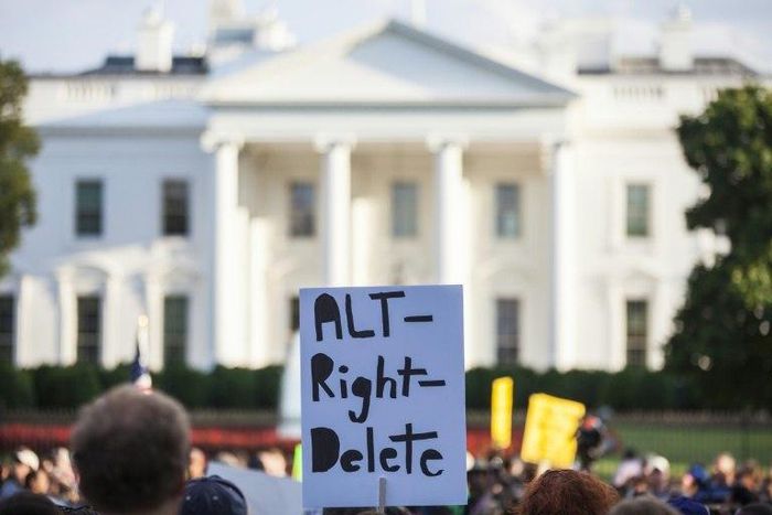 A demonstrator holds a sign in front of the White House during a vigil in response to the death of a counter-protestor in the August 12 "Unite the Right" rally in Charlottesville, Virginia