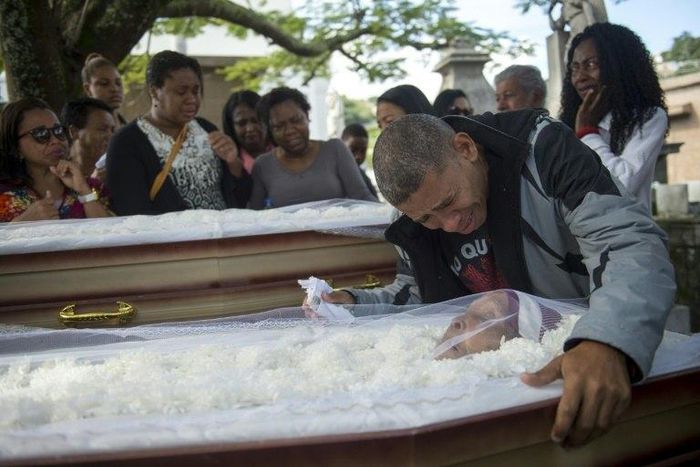 Luis Carlos de Oliveira, 49, mourns his relatives Ana Cristina da Conceicao, 42, and her mother, Marlene Maria da Conceicao, 76, killed by stray bullets during a firefight between police and traffickers in the Mangueira shantytown, in Rio de Janeiro in...