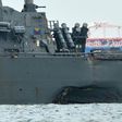 The USS John S. McCain with a hole on its port side