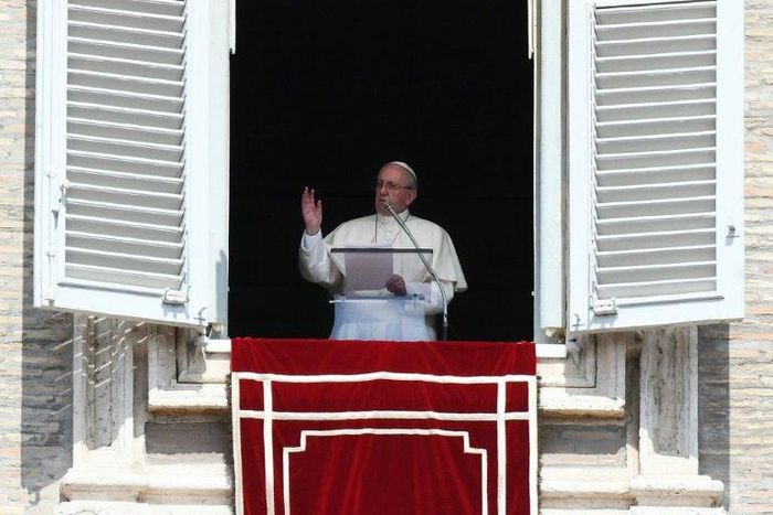Pope Francis waves to pilgrims gathered in St. Peter's square during his Sunday Angelus prayer on August 20, 2017 at the Vatican