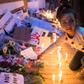 A Moroccan girl places a flower during a vigil for the two Scandinavian hikers, who were killed in Morocco's High Atlas mountains, outside the Danish Embassy in Rabat on December 22, 2018