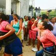 Relatives of inmates struggle with riot police outside Las Cruces prison in Acapulco, following a riot in the facility that left 28 dead and three wounded