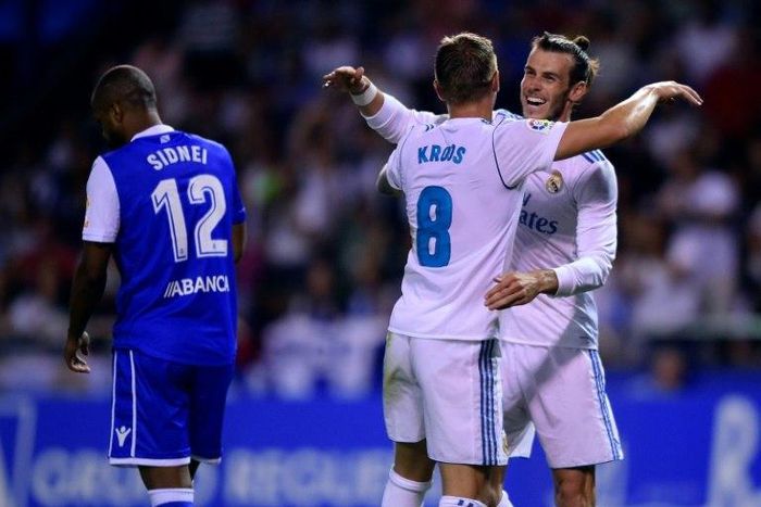 Real Madrid's midfielder Toni Kroos (C) celebrates with teammate Gareth Bale scoring on August 20, 2017