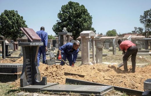 Gravediggers in Johannesburg, where between 45 and 60 graves are re-opened each week on average to allow for second burials