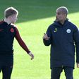 Manchester City's Spanish manager Pep Guardiola (R) talks with midfielder Kevin De Bruyne during a training session at Manchester City Football Academy Campus