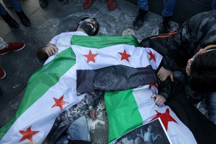 Protesters in Paris act out the role of victims of the April 2017 sarin gas attack, just days after scores died in the Syrian town of Khan Sheikhun