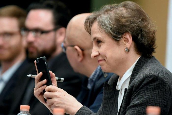 Mexican journalist Carmen Aristegui holds her mobile phone during a press conference in Mexico City, on June 19, 2017