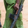 Anonymous uniformed Kenyan police officers hold guns
