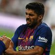 Barcelona's Uruguayan forward Luis Suarez grimaces as he sits on the ground during the Spanish Supercup match against Real Madrid in Madrid, on August 16, 2017
