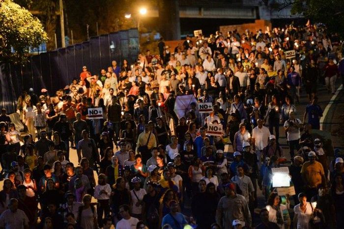Opposition demonstrators march towards OAS headquarters in Caracas after the OAS General Assembly rules out issuing a resolution on the crisis in Venezuela
