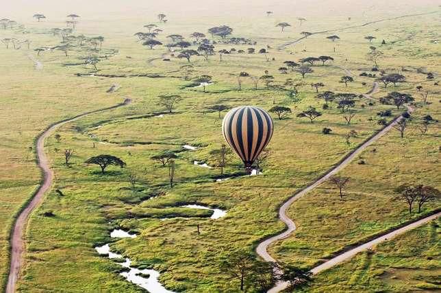 An hot air balloon flies over famed Maasai Mara game reserve in Kenya. (Art of Safari)