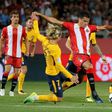 Atletico Madrid's forward Antoine Griezmann (L) vies with Girona's Bernando Espinosa during the Spanish league football match August 19, 2017