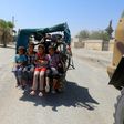 Displaced Syrian children ride in the back of a vehicle in Raqa's western al-Sabahiya district where they are taking shelter