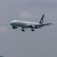 A Cathay Pacific passenger plane makes its descent before landing at Hong Kong's international airport on August 16, 2017