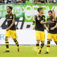 Dortmund players celebrate scoring the opening goal during the Bundesliga match against Wolfsburg