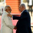 Israeli Prime Minister Benjamin Netanyahu (R) greets his Indian counterpart Narendra Modi (L) at Ben Gurion airport near Tel Aviv on July 4, 2017