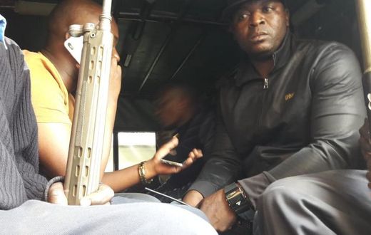 Embakasi Central MP Benjamin Gathiru (in yellow shirt) at the back of a police Land Rover (Twitter)