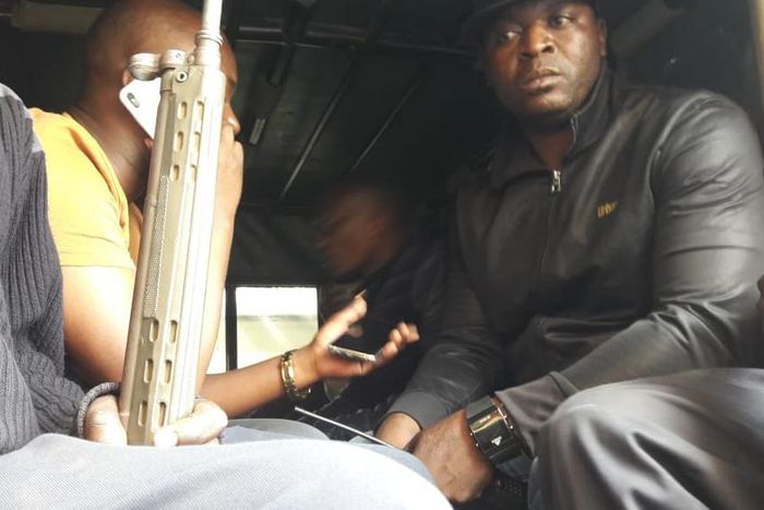 Embakasi Central MP Benjamin Gathiru (in yellow shirt) at the back of a police Land Rover (Twitter)