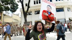 A government supporter holding a picture of late Venezuelan leader Hugo Chavez shouts slogans in favor of the new Constituent Assembly, which began work on Friday