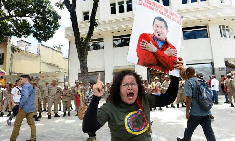 A government supporter holding a picture of late Venezuelan leader Hugo Chavez shouts slogans in favor of the new Constituent Assembly, which began work on Friday