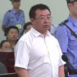 This handout video frame grab taken and released by Changsha Intermediate People's Court on August 22, 2017 shows Chinese rights lawyer Jiang Tianyong (C) appearing in court in Changsha