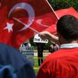 Pro-Erdogan supporters wave Turkish flags at anti-government protesters in front of the White House in Washington, DC on May 16, 2017