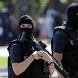 Armed police officers patrol the Champs-Elysees in Paris on June 19, 2017