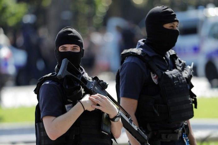 Armed police officers patrol the Champs-Elysees in Paris on June 19, 2017