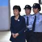 South Korean ousted leader Park Geun-Hye (left) arrives at the Seoul Central District Court in Seoul on May 25, 2017 for her trial over the massive corruption scandal that led to her downfall