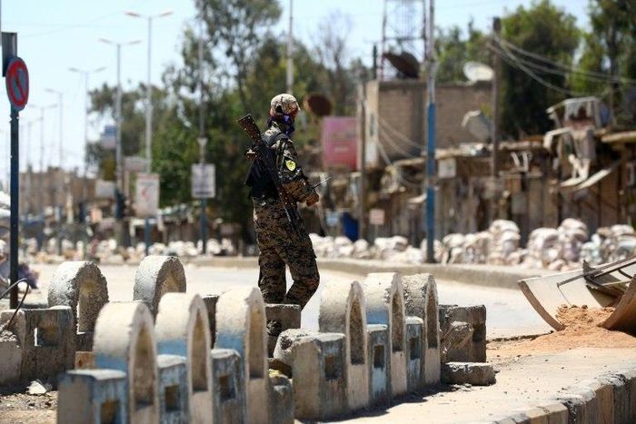 A member of the US-backed Syrian Democratic Forces (SDF) patrols a street in Syrian town of Tabqa, in May 2017, as they advance their battle to the Islamic State's stronghold in nearby Raqa