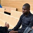 Toulouse football player Odsonne Edouard (R) speaks with his lawyer Pierre Le Bonjour prior to his hearing for "arms-based violence", on June 13, 2017 at Toulouse courthouse