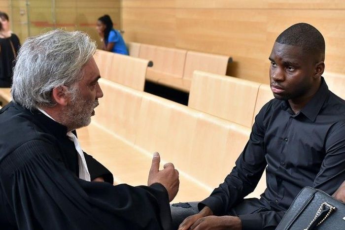 Toulouse football player Odsonne Edouard (R) speaks with his lawyer Pierre Le Bonjour prior to his hearing for "arms-based violence", on June 13, 2017 at Toulouse courthouse