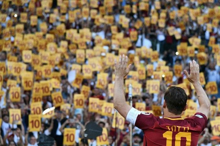 Roma's captain Francesco Totti greets fans holding placards with his number 10 during a ceremony following his last match with AS Roma after the Italian Serie A football match against Genoa in Rome May 28, 2017