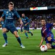 Real Madrid's Toni Kroos (L) fights for the ball with Barcelona's Sergio Busquets during the first leg of their Spanish Super Cup match, at Camp Nou in Barcelona, on August 13, 2017