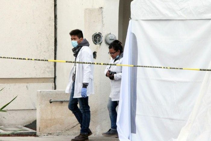 Forensic personnel work on a crime scene where attackers burst into a party and killed 11 people in Tizayuca, Mexico