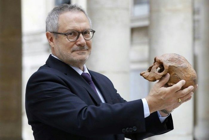 French paleoanthropologist Jean-Jacques Hublin poses with the casting of a Homo Sapiens skull discovered in Morocco. The human species roamed Africa 300,000 years ago, according to new research that pushes back human origins by 100,000 years.