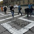 Journalists paint "#sosprensa" (SOS Press) in Mexico City's Zolcalo Square during a protest over the slaying of Salvador Adame, the 6th reporter killed in Mexico this year